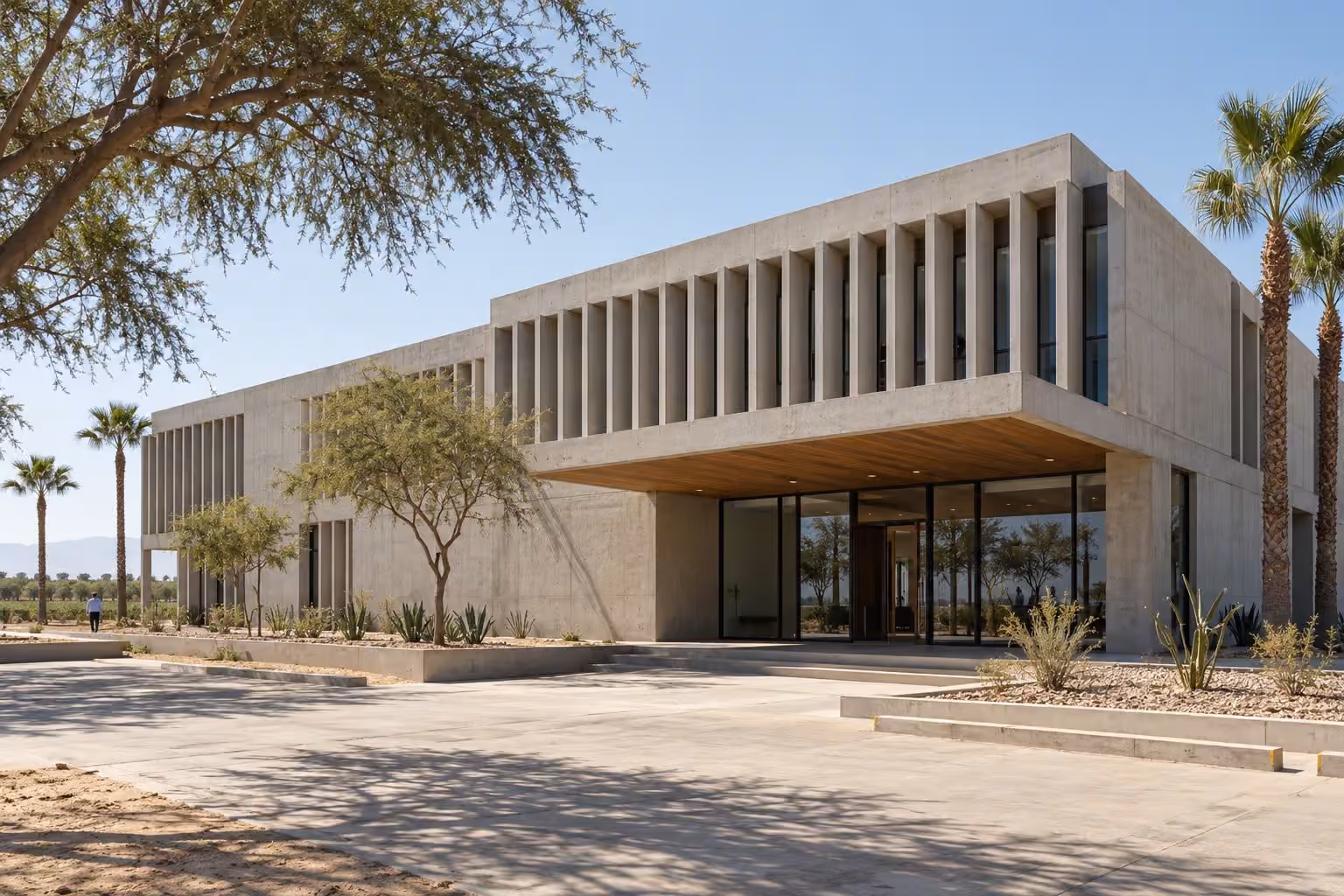 Edificio de oficinas de concreto caravista con parasoles verticales